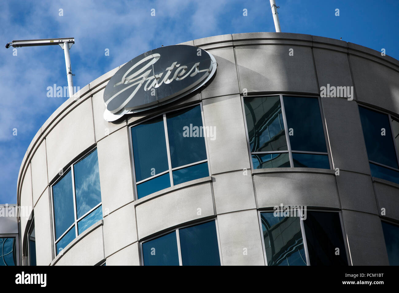 A logo sign outside of the headquarters of the Gates Corporation in