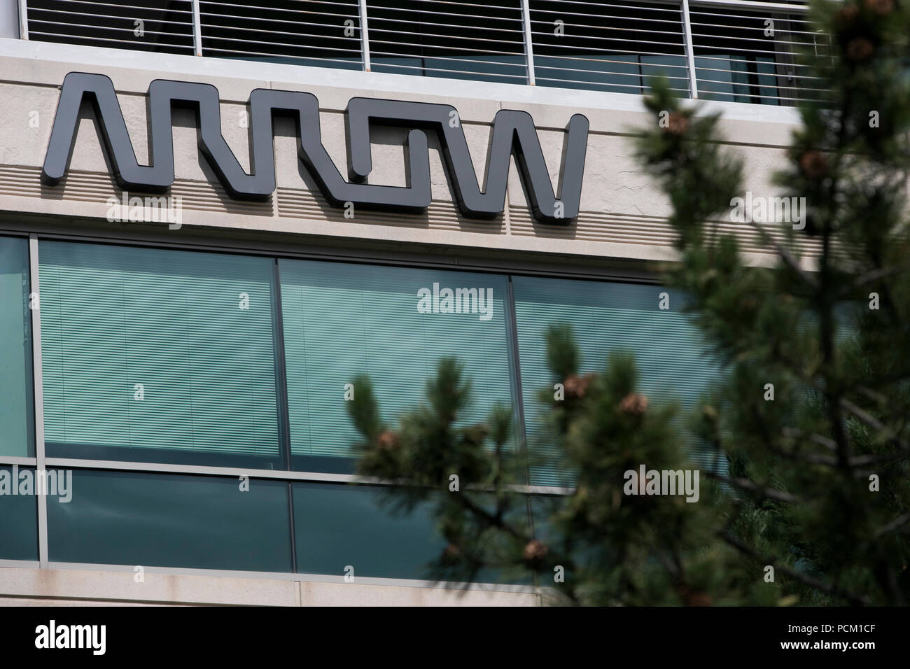 A logo sign outside of the headquarters of Arrow Electronics in