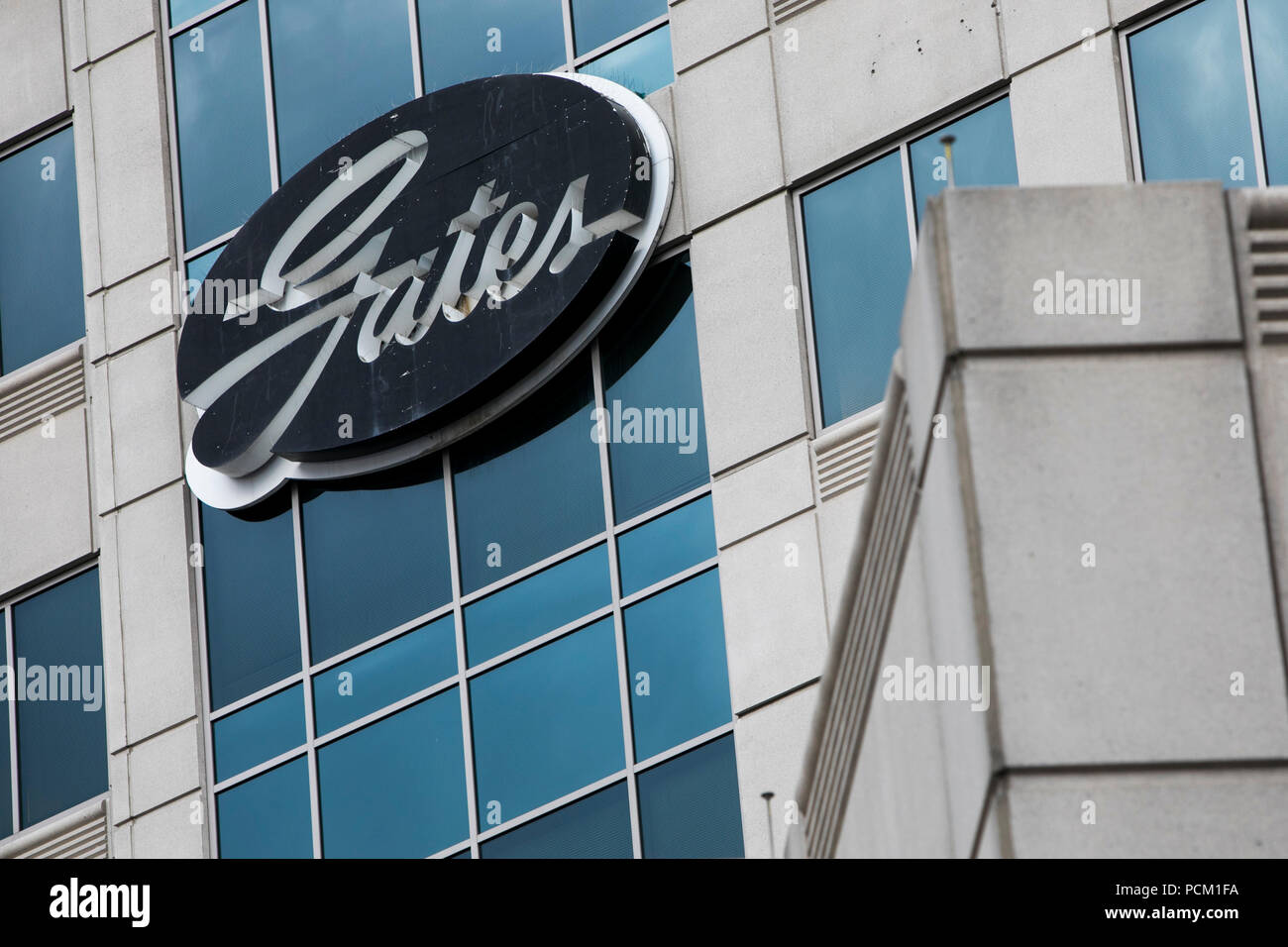 A logo sign outside of the headquarters of the Gates Corporation in