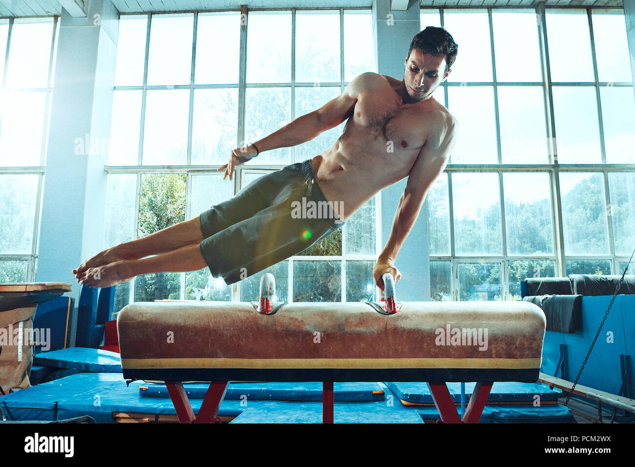 The Sportsman During Difficult Exercise Sports Gymnastics Stock Photo the-sportsman-during-difficult-exercise-sports-gymnastics-stock-photo