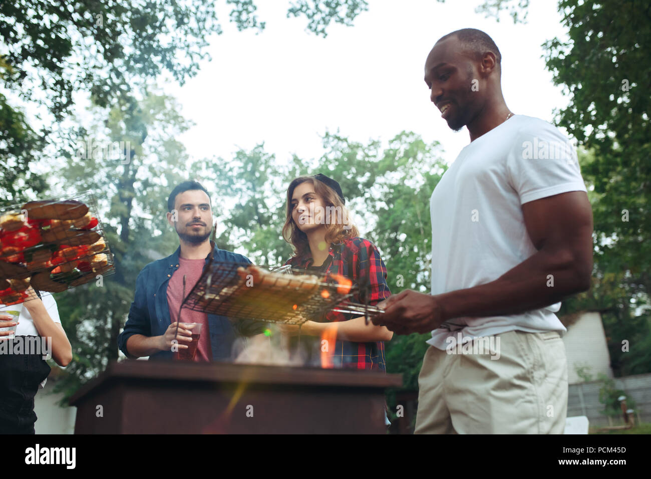 Group of friends making barbecue in the backyard. concept about good and positive mood with friends Stock Photo