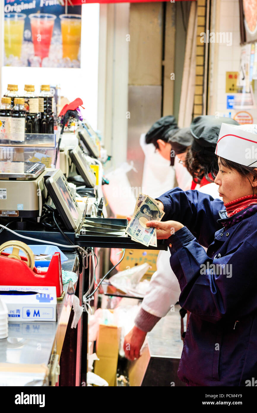 Kuromon Ichiba Osaka S Kitchen Food Market Woman Shop Cashier Taking Money From Till To Give Unseen Customer His Change Row Of Tills And Staff Stock Photo Alamy