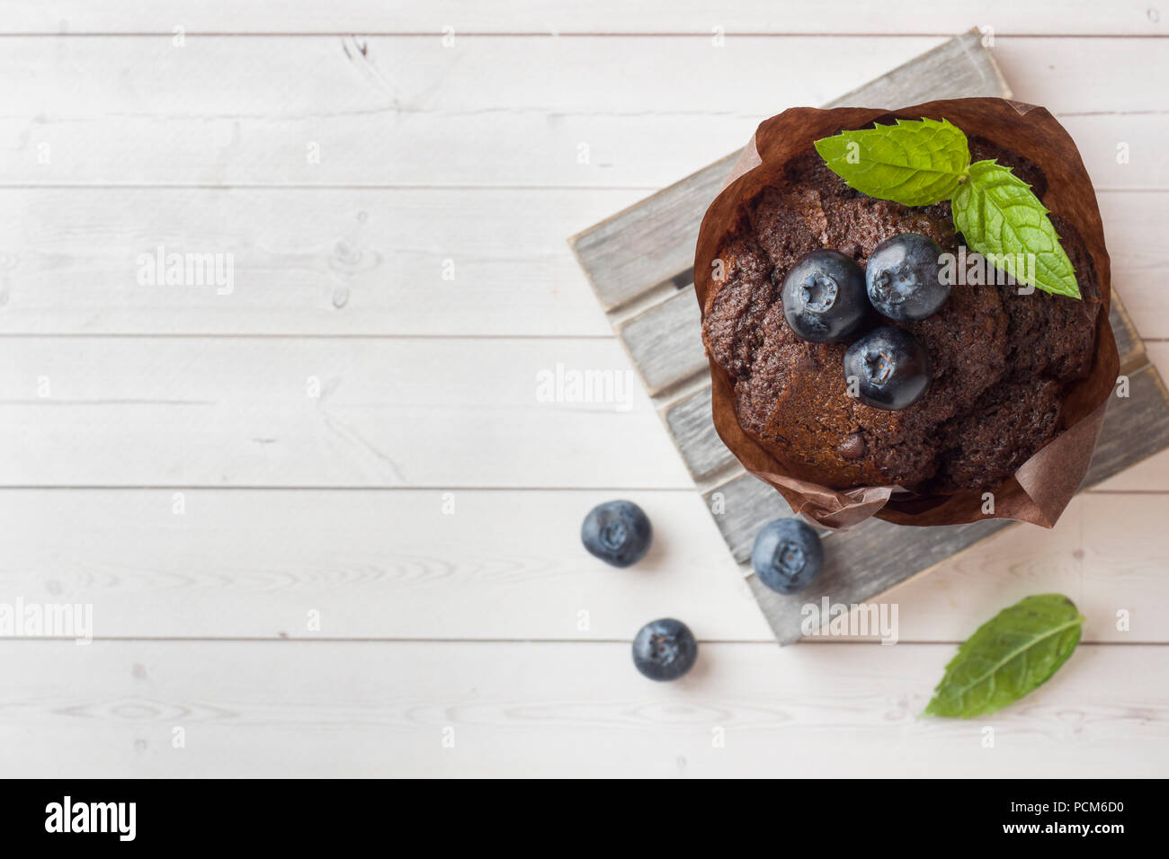 Chocolate cake with mint and blueberries on a wooden stand Stock Photo ...