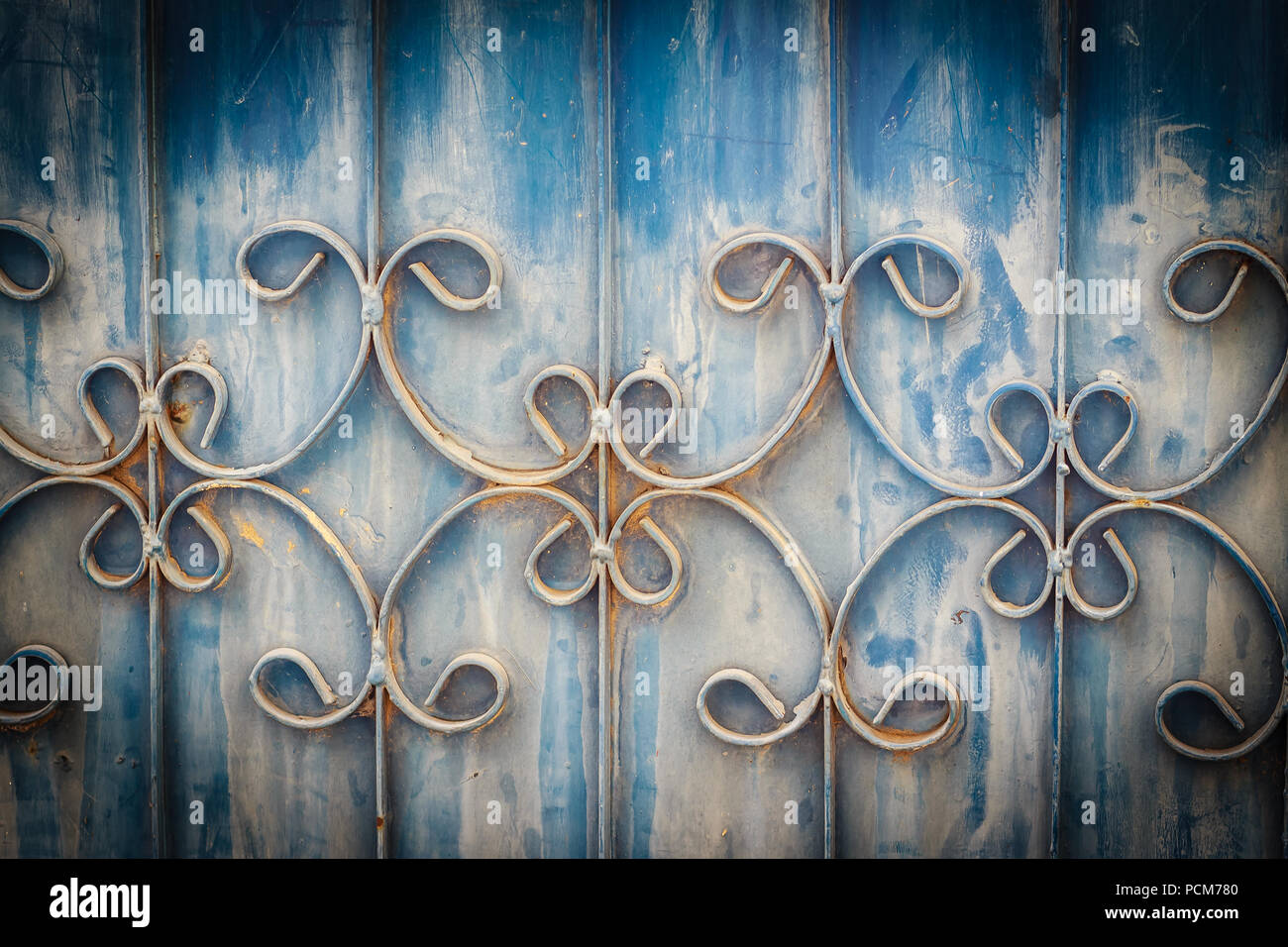 Old wrought iron bars on the gate with grunge and rusty steel