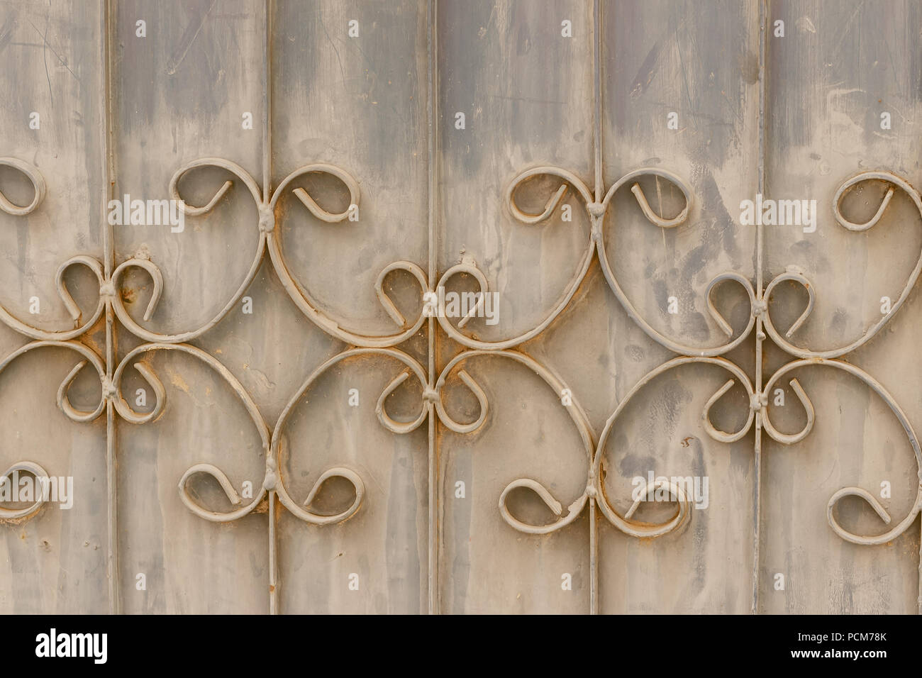 Old wrought iron bars on the gate with grunge and rusty steel