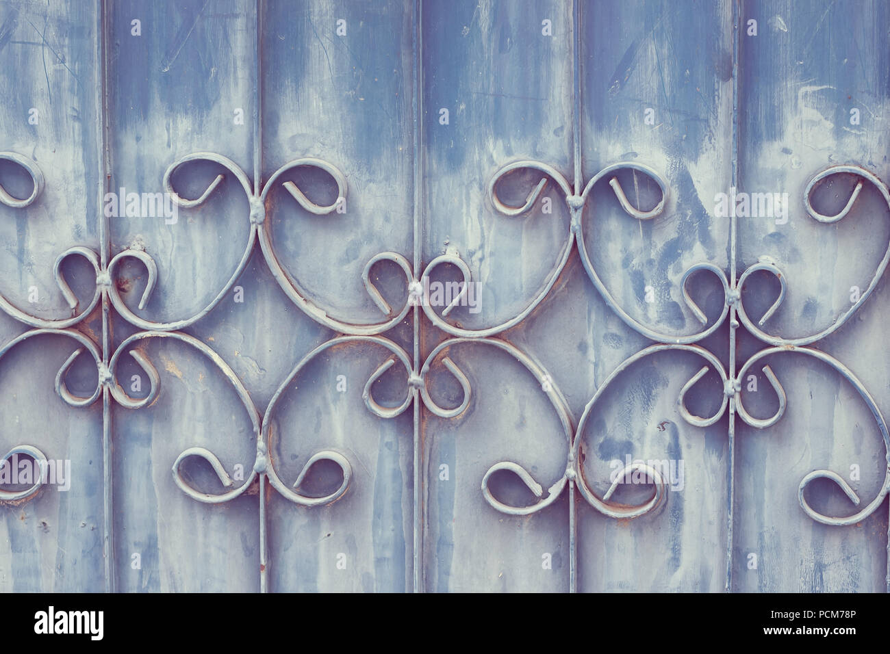Old wrought iron bars on the gate with grunge and rusty steel