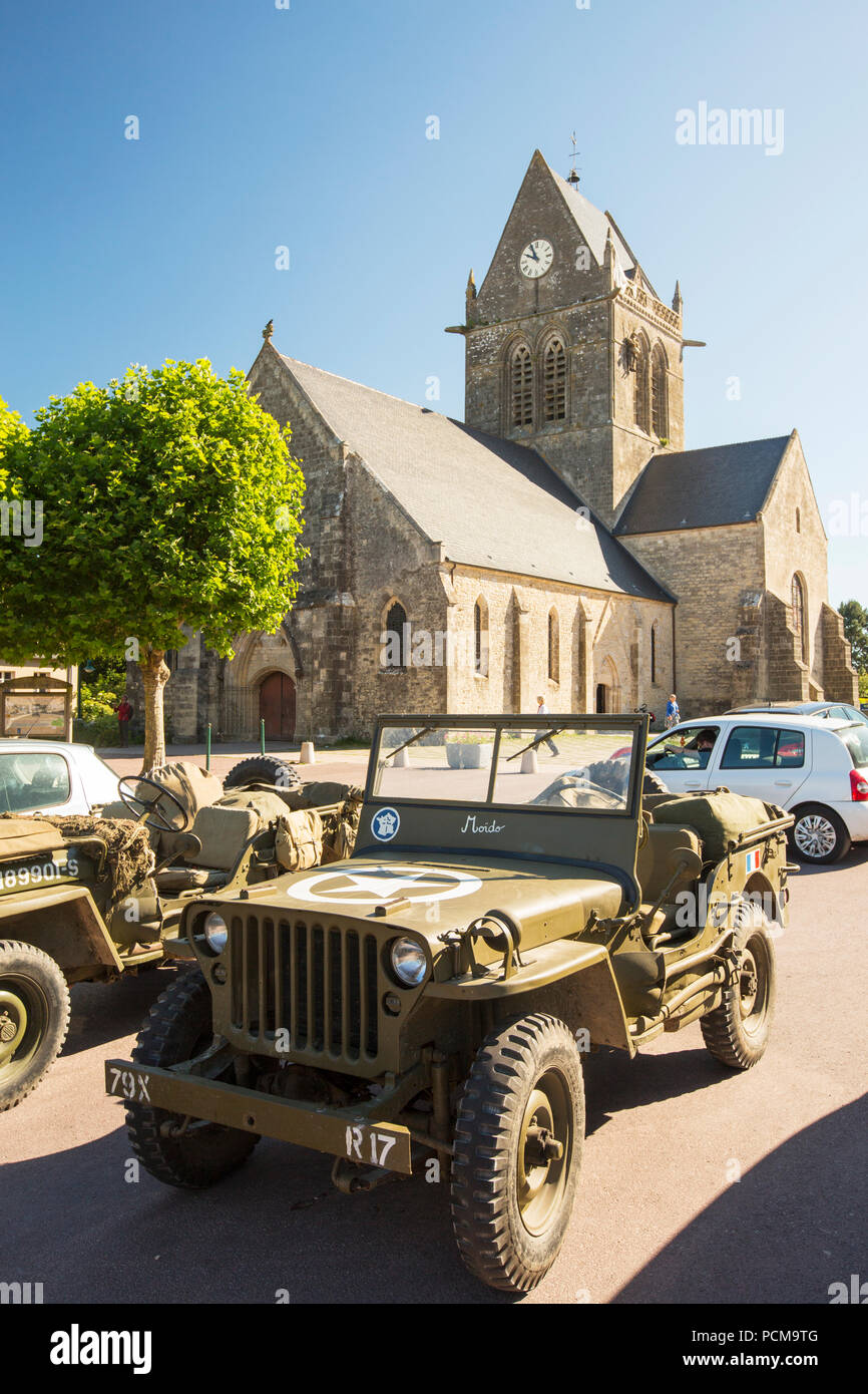 Jeeps infront of the parachute memorial on the church in Sainte Mere