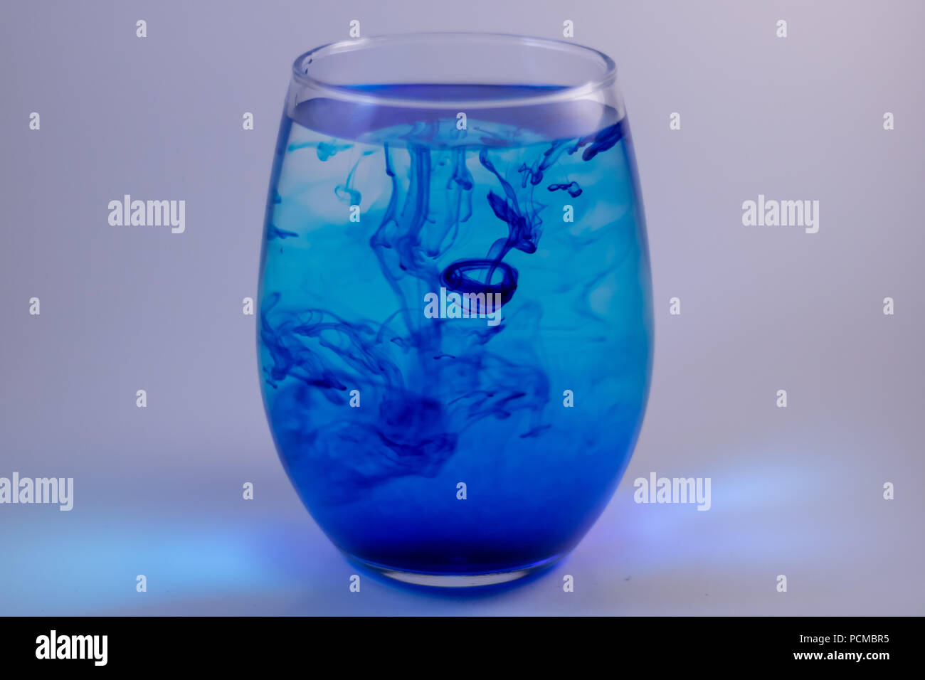 Blue food coloring added to water to create fascinating patterns. Stock Photo