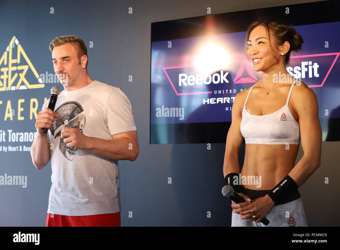 Tokyo, Japan. 2nd Aug, 2018. Danish former K-1 fighter and fitness trainer  Nicholas Pettas (L) speaks withJapanese fitness trainer and model AYA (R)  as she shows her crossfit exercise at the newly