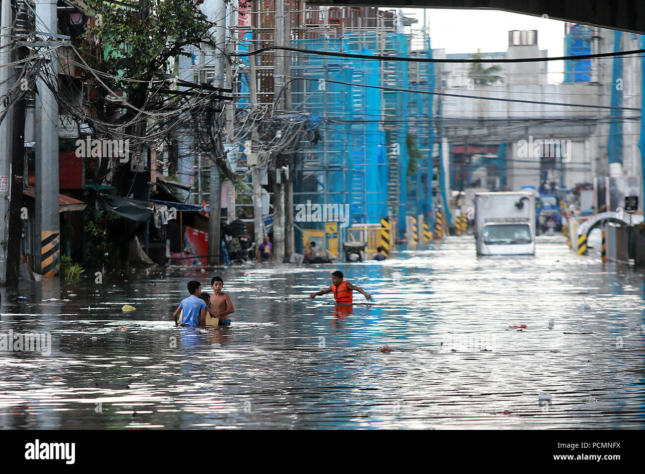 Quezon City, Philippines. 3rd Aug, 2018. A truck is immobilized by the  flood after a heavy monsoon rain in Quezon City, Metro Manila, the  Philippines, Aug. 3, 2018. Several streets and residential