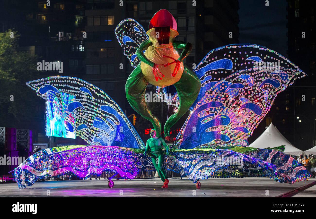 Toronto, Canada. 2nd Aug, 2018. A dressed up competitor performs with his float during the King and Queen Competition of the 2018 Peeks Toronto Caribbean Carnival in Toronto, Canada, Aug. 2, 2018. Dozens of talented masqueraders with their extravagant costumes took part in this annual event on Thursday to compete for the King and Queen of the Carnival. Credit: Zou Zheng/Xinhua/Alamy Live News Stock Photo