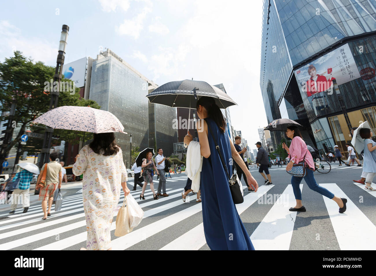 Pedestrians shade themselves with parasols in the heat in Ginza shopping district on August 3, 2018, in Tokyo, Japan. Temperatures topped 37 degrees Celsius in Tokyo, on Friday at 2 pm. According to the Tokyo Medical Examiner's Office, ninety-six people died of heatstroke in central Tokyo's 23 wards during the month of July, nearly four times as many as in the same period in 2017. Credit: Rodrigo Reyes Marin/AFLO/Alamy Live News Stock Photo