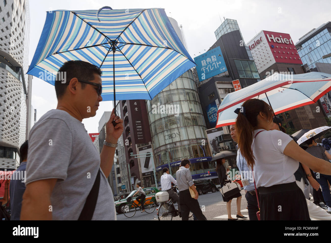 Pedestrians shade themselves with parasols in the heat in Ginza shopping district on August 3, 2018, in Tokyo, Japan. Temperatures topped 37 degrees Celsius in Tokyo, on Friday at 2 pm. According to the Tokyo Medical Examiner's Office, ninety-six people died of heatstroke in central Tokyo's 23 wards during the month of July, nearly four times as many as in the same period in 2017. Credit: Rodrigo Reyes Marin/AFLO/Alamy Live News Stock Photo