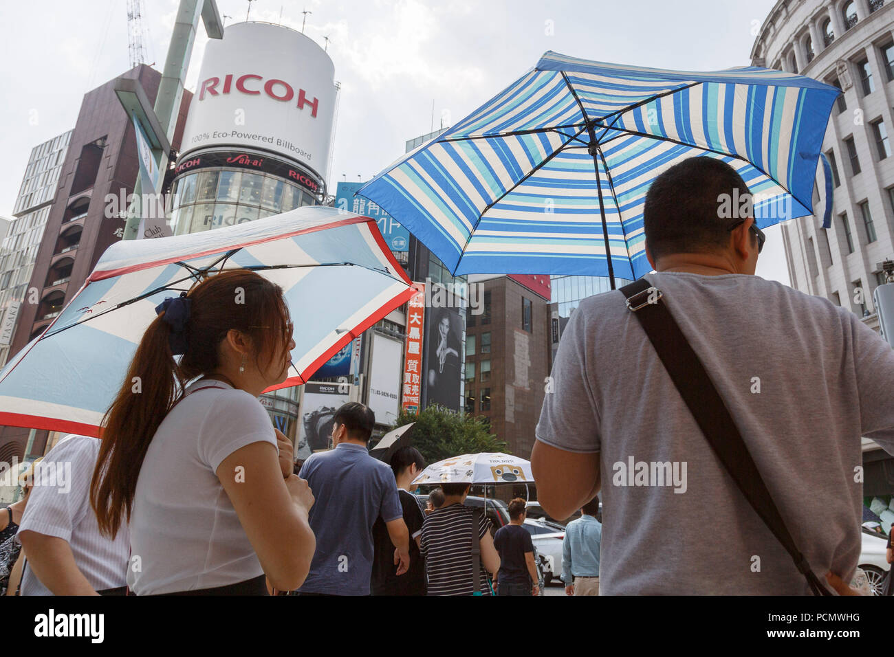 Pedestrians shade themselves with parasols in the heat in Ginza shopping district on August 3, 2018, in Tokyo, Japan. Temperatures topped 37 degrees Celsius in Tokyo, on Friday at 2 pm. According to the Tokyo Medical Examiner's Office, ninety-six people died of heatstroke in central Tokyo's 23 wards during the month of July, nearly four times as many as in the same period in 2017. Credit: Rodrigo Reyes Marin/AFLO/Alamy Live News Stock Photo