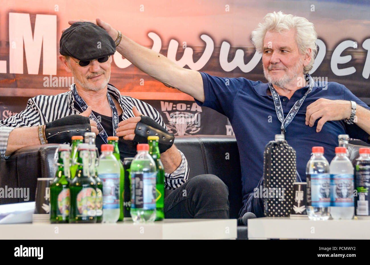 Wacken, Germany. 03rd Aug, 2018. Roetger Feldmann (L) alias 'Broesel', cartoonist and Holger Henze, innkeeper, clowning around during the Wacken Open Air at a press conference on the 'Werner Race'. The new edition of the race between Feldmann and the innkeeper Henze will take place at a festival from 30 August to 2 September 2018 in Hartenholm in Schleswig-Holstein. Credit: Axel Heimken/dpa/Alamy Live News Stock Photo