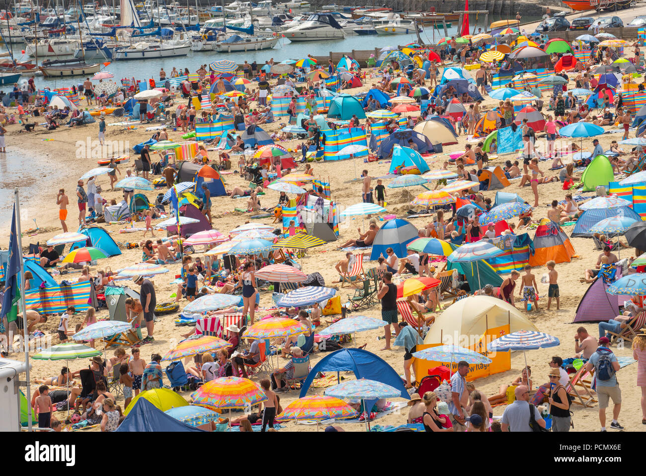 Lyme Regis, Dorset, UK. 3rd August 2018.  UK Weather: Scorching hot sunshine and blue sky in Lyme Regis.  Holidaymakers and sunseekers flock to the packed beach at the seaside resort of Lyme Regis this afternoon as temperatures soar on what is set to be the hottest day on record. Credit: Celia McMahon/Alamy Live News Stock Photo