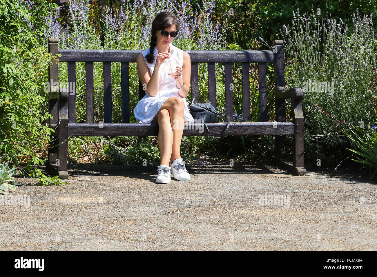 Hyde Park London Uk 3 Aug 2018 A Woman Sitting On A Park Bench