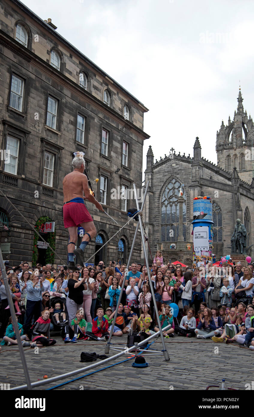 Opening day of 2018 Edinburgh Fringe Festival, Scotland UK, 3 Aug.2018. Big audiences for the street performers on the city's Royal Mile for the first day of the 2018 Edinburgh Fringe Festival. Also, first day of the availability of 'Tap to Tip' machines where audience members can donate a tip for performers at special boxes adjacent to some performer pitches and stages. Stock Photo