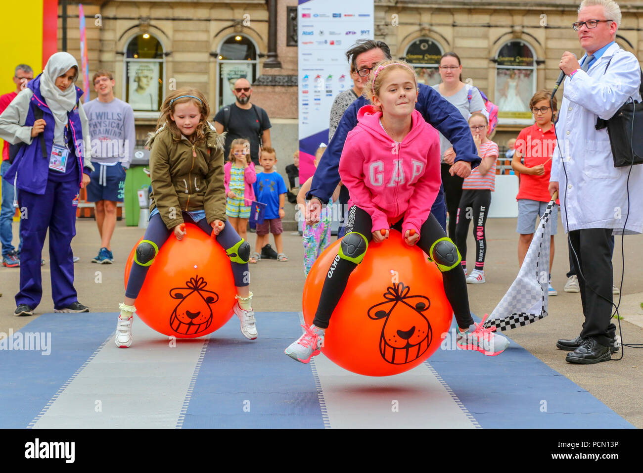 Glasgow, UK. 3rd July 2018, The Great Spacehopper Challenge took place in George Square, Glasgow as part of the Festival 2018 and European Games entertainments with children showing off their skills of balance, racing and really having fun. Here the race is between (L-R) Lexie Pickles, age 9 from Halifax, England  and Sophie McKenzie, age 6 from Paisley Credit: Findlay/Alamy Live News Stock Photo