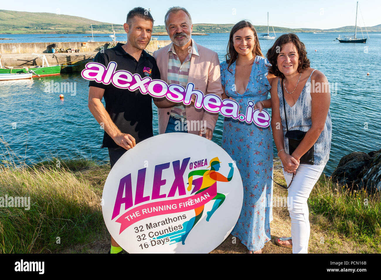 Ahakista, West Cork, Ireland. 3rd Aug, 2018.  As part of the Ahakista August Festival, Graham Norton hosts the Annual Graham Norton Table Quiz.  Special guest, Jennifer Barry (from the Young Offenders), also attended the festival. Graham and Jennifer are pictured with Alex O'Shea, a Cork based fireman who is running 32 marathons in 32 counties over 16 days and Jennifer's mum, Christine. The proceeds of the quiz are going to the Ahakista Community Association.  Credit: Andy Gibson/Alamy Live News. Stock Photo
