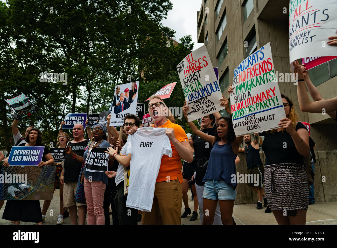 New York, New York, U.S., 3 August 2018 Supporters of immigration activist Therese Patricia Okoumou rally after she appeared in federal court in Manhattan for a hearing on trespassing and disorderly conduct charges.  Okoumou scaled the base of the Statue of Liberty on July 4, 2018, to protest against Trump administration immigration policies.  Okoumou wore a green dress to court bearing the words “I really care why won’t u?” – a response to first lady Melania Trump, who wore a jacket with the words “I really don’t care, do u?” when she visited a facility for migrant children in June. Stock Photo