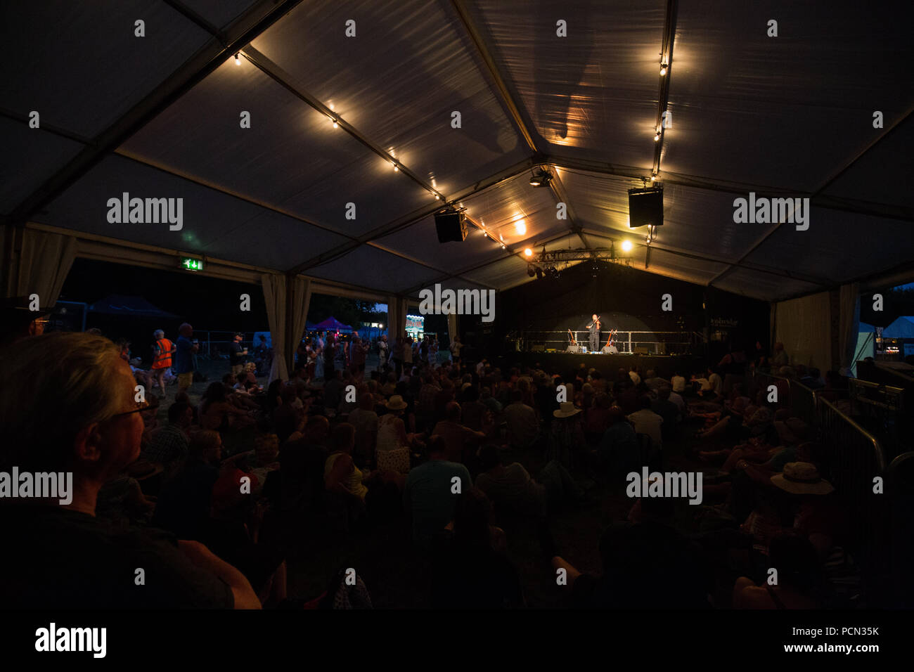 Cambridge, UK. 3rd August, 2018. Festival crowds during the early evening at the Cambridge Folk Festival. Richard Etteridge / Alamy Live News Stock Photo