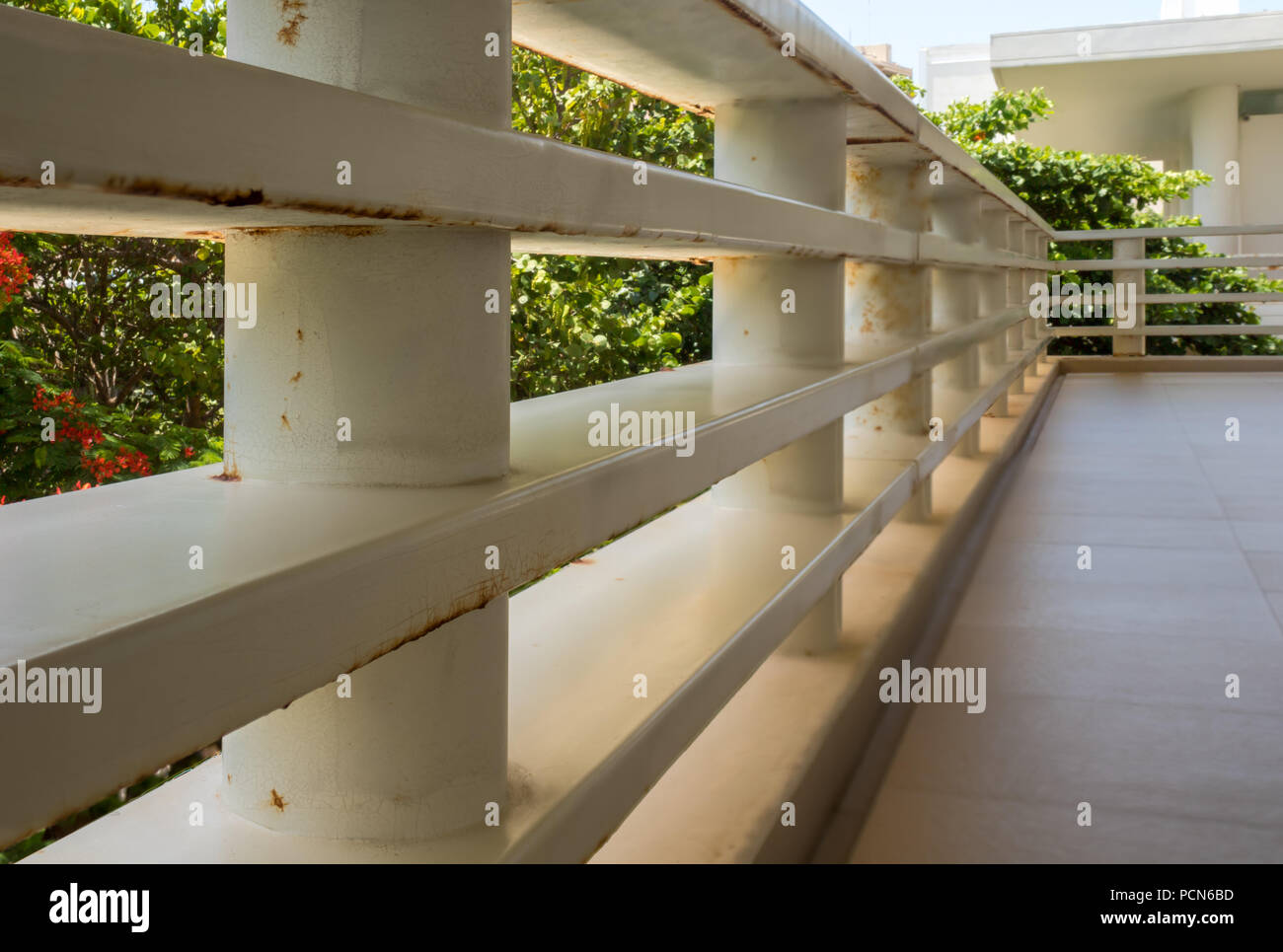 Cancun, Mexico; JUL 15 2018: metal white railing with some rusty sports ...
