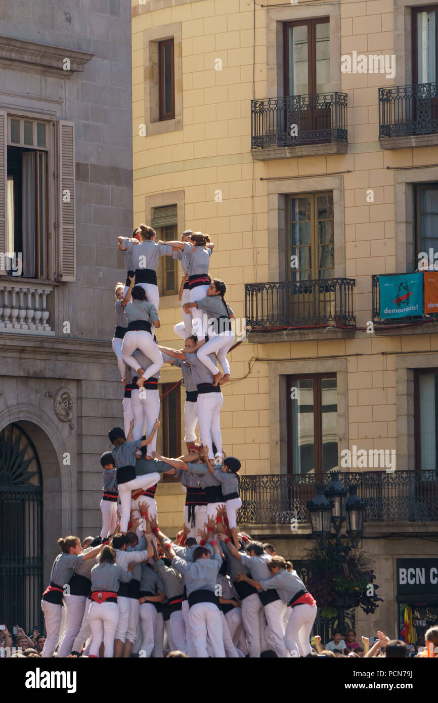 people building a human pyramid during the festival in catalunya, spain ...