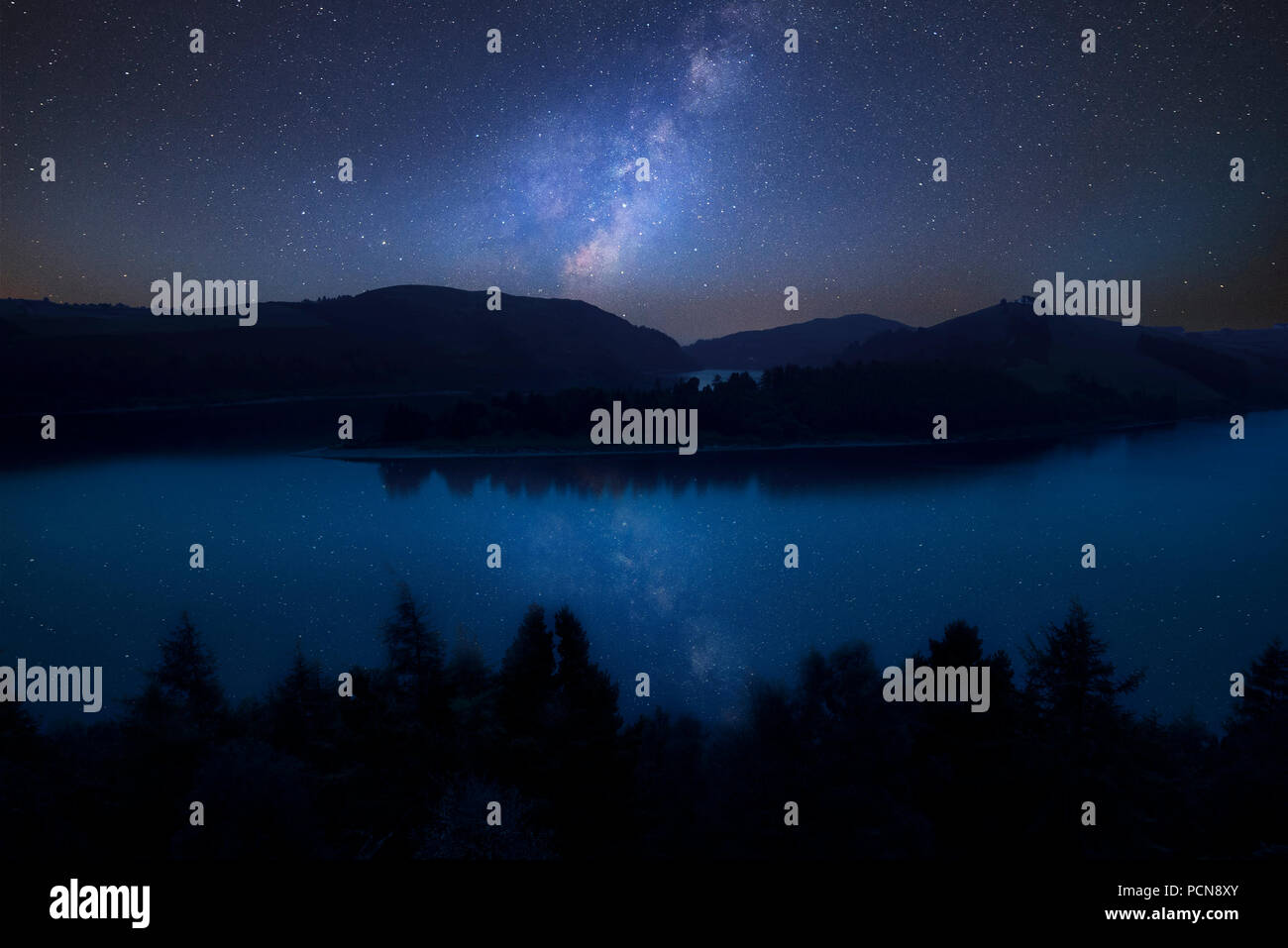 Stunning vibrant Milky Way composite image over landscape of moody ...