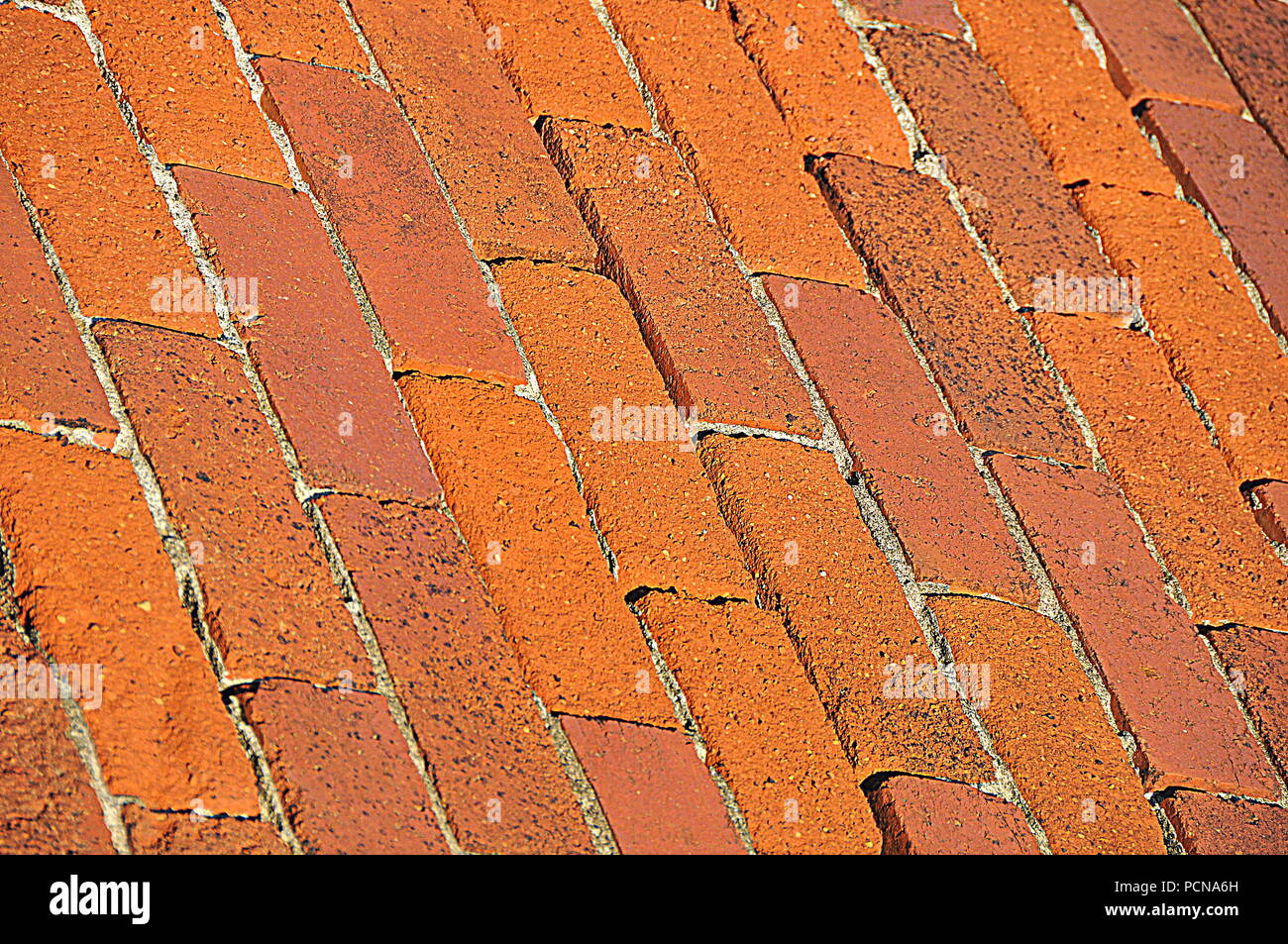 A broken red brick wall, now used as part of a breakwater construction in Evans Bay, Wellington Stock Photo