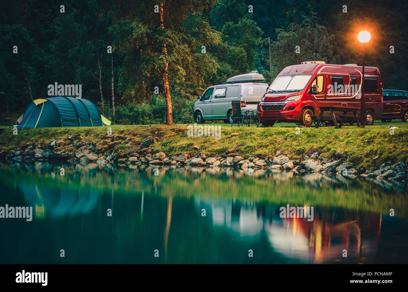 RV Park Camping in Norway. Waterfront Campsites with Camper Vans and Tents. Stock Photo