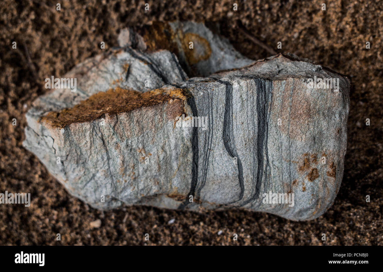 Geological Metamorphic Rock with three planes of geological fault shows undergoing trasition from Igneous rock to Sedimentary Rock. History of Earth. Stock Photo