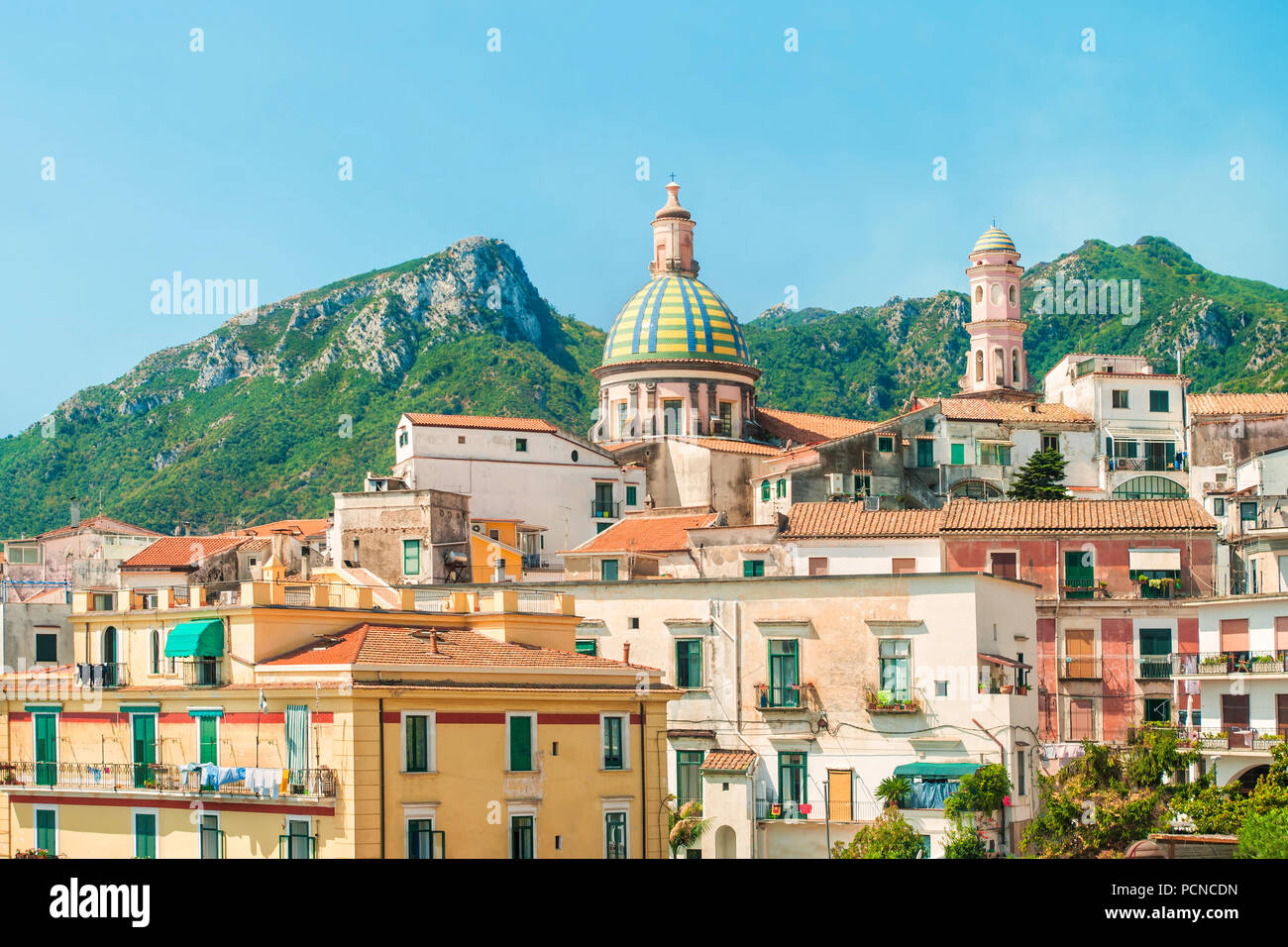 view of small Italian town in morning with beautiful Parrocchia San Giovanni church and mountains in background, Vietri Sul Mare, Salerno, Campania, I Stock Photo