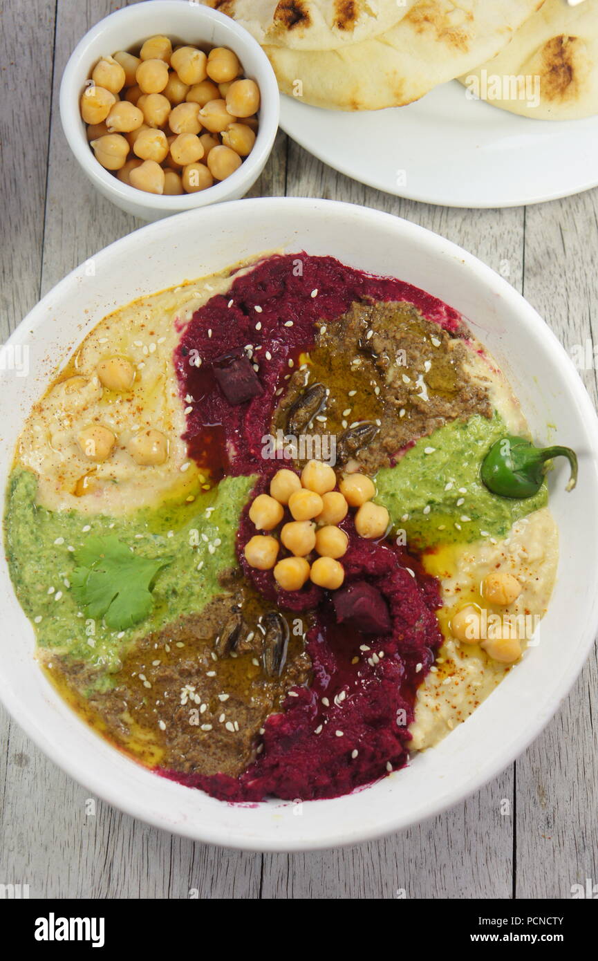 Various Flavors of hummus (beet with balsamic vinegar, jalapeno and cilantro, and cricket flour) Stock Photo