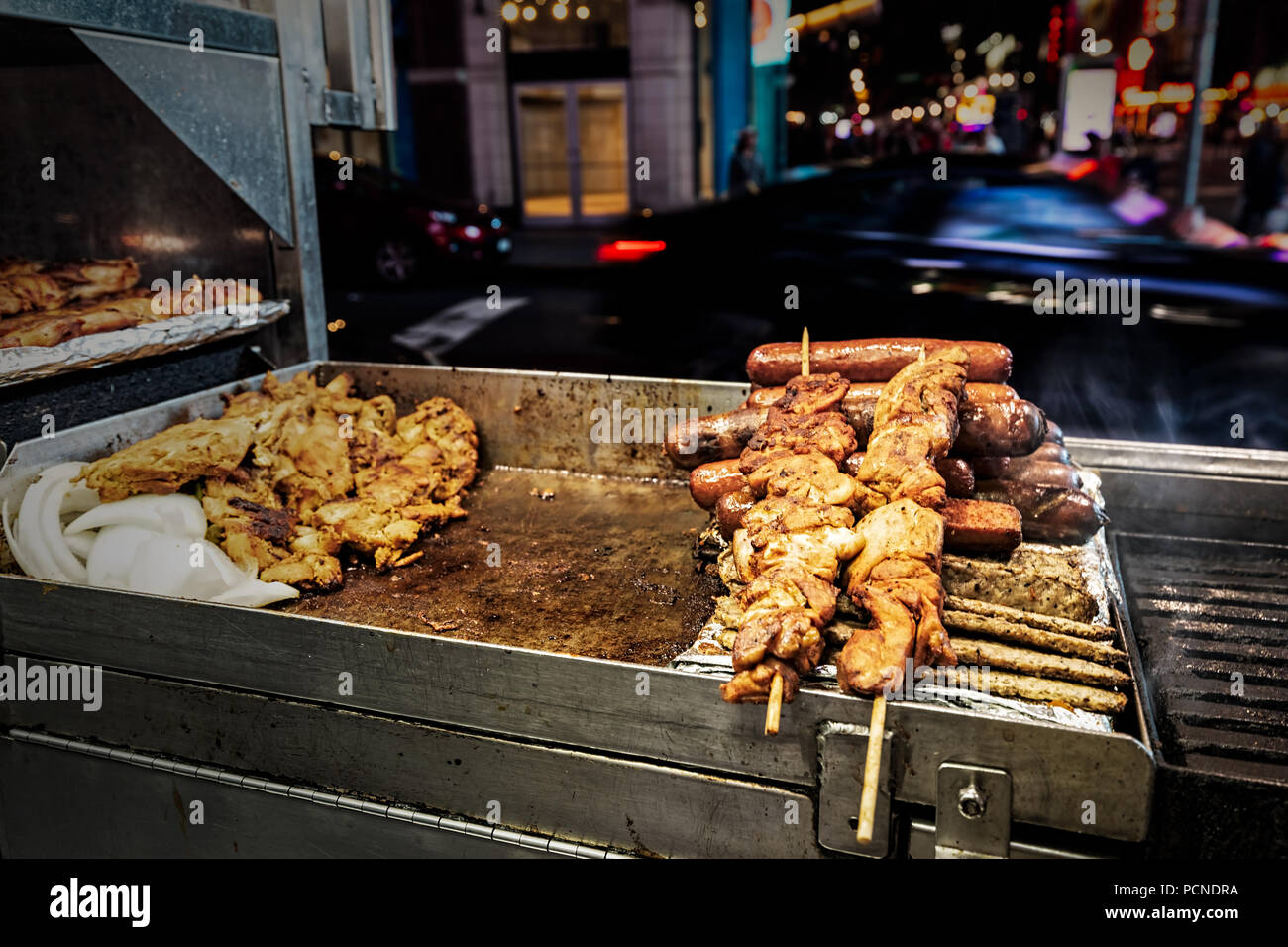 https://c8.alamy.com/comp/PCNDRA/a-grill-at-a-food-stand-in-new-york-city-with-chicken-sausages-and-kebabs-on-skewers-PCNDRA.jpg