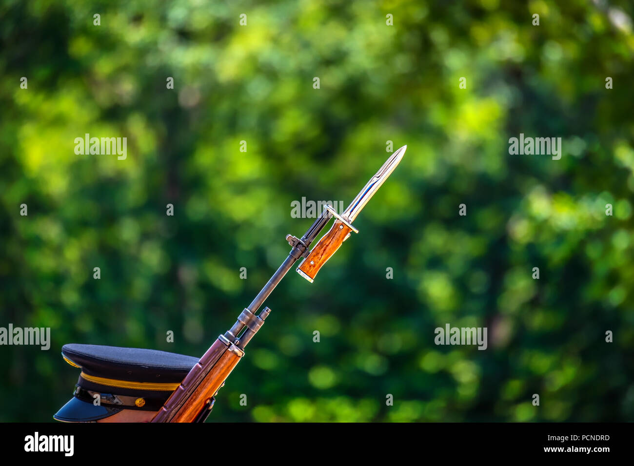 The head and hat of a US Army soldier carrying his rifle on guard duty. Stock Photo