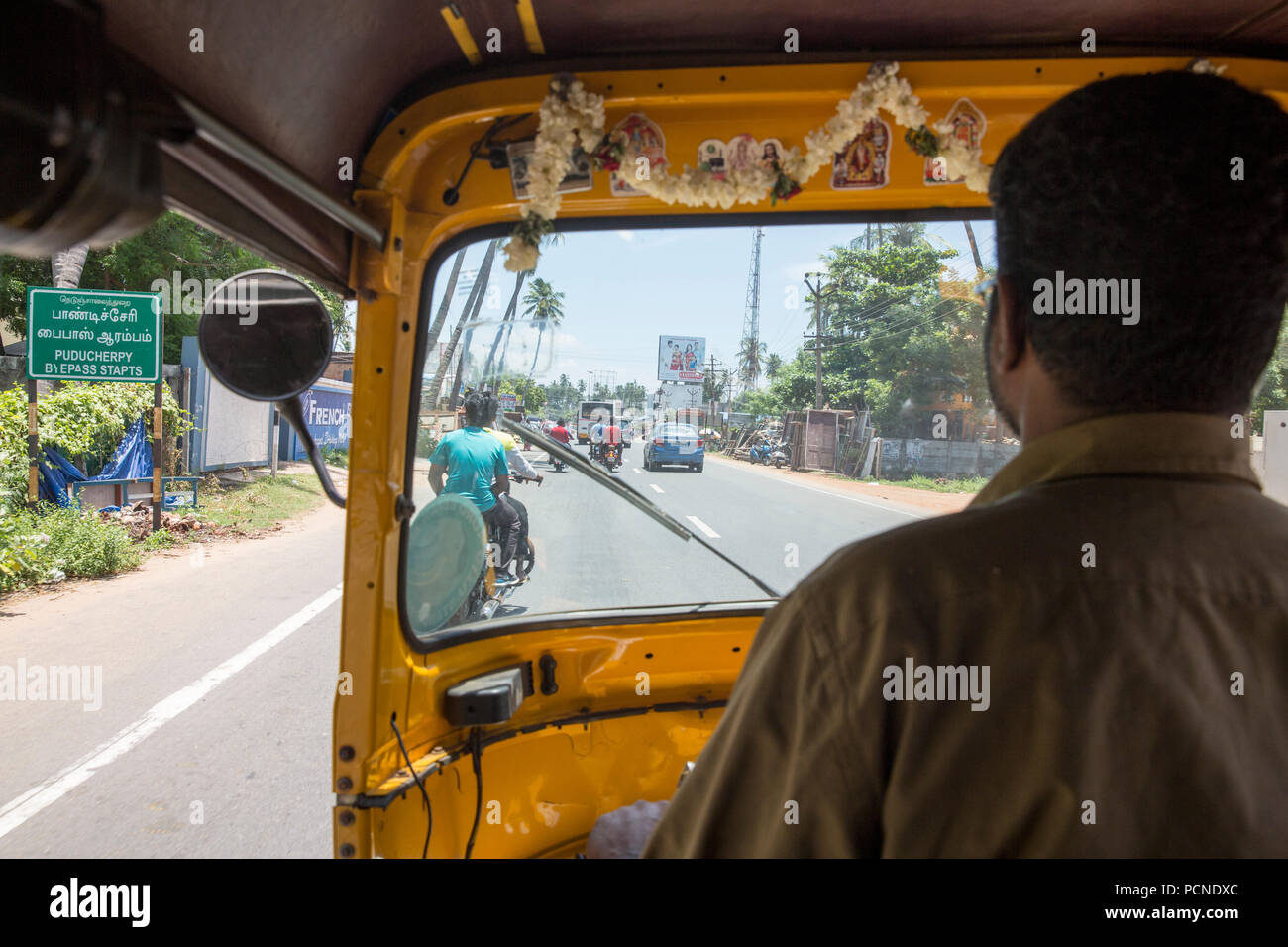 view from the back of auto rickshaw as a passenger. Stock Photo