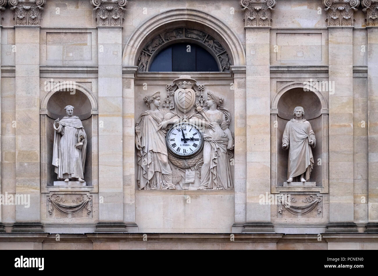 St. Thomas Aquinas, Pierre Lombard, muses support the clock, topped by the coat of arms of Cardinal Richelieu, facade of the St Ursule chapel of the S Stock Photo