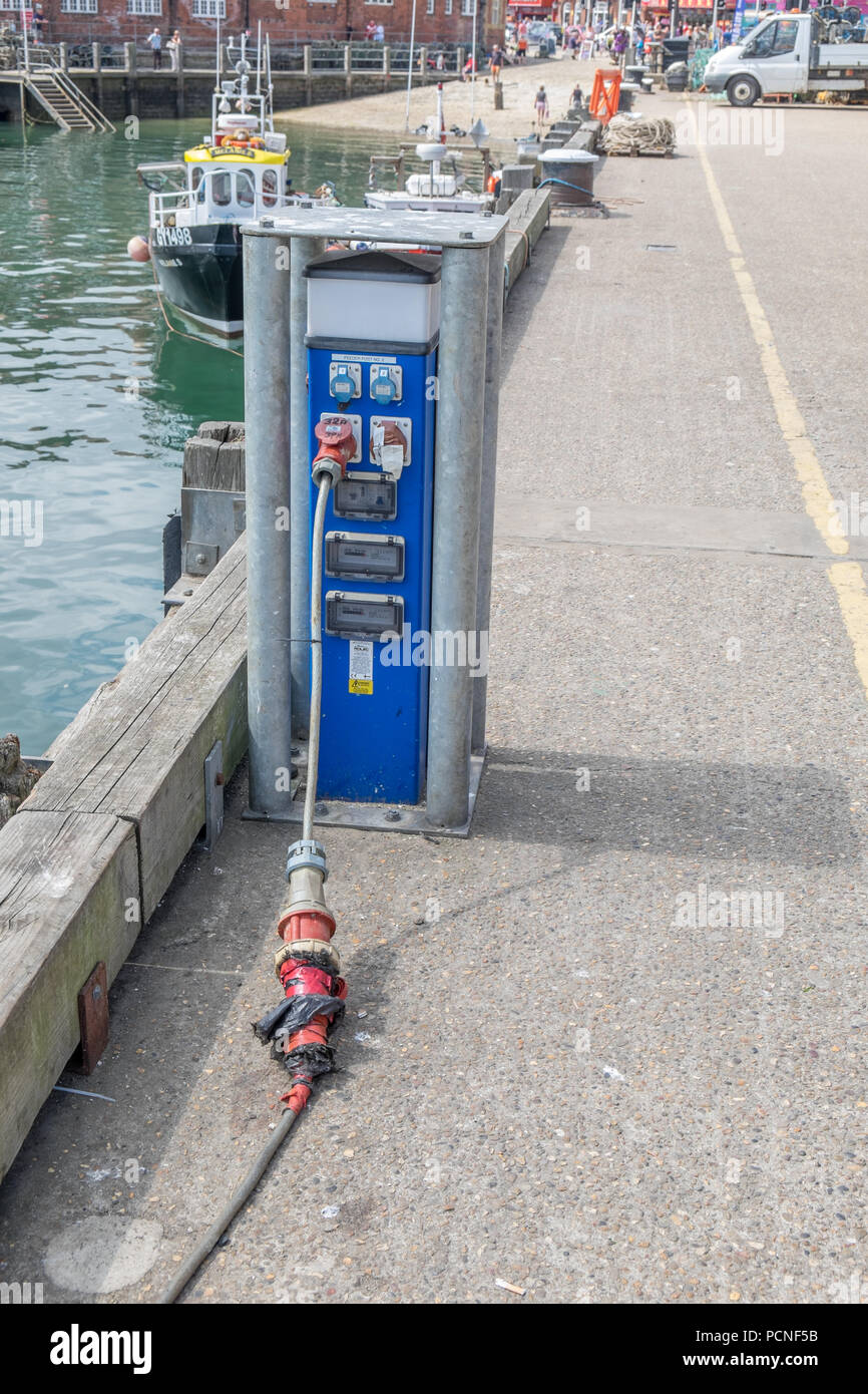 Electrical power supply for ships and boats on the harbour in Scarborough  Stock Photo - Alamy
