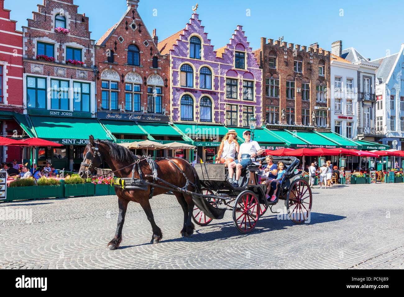 Tourists being taken on city tour with a horse and trap in the Markt Square, Bruges Stock Photo