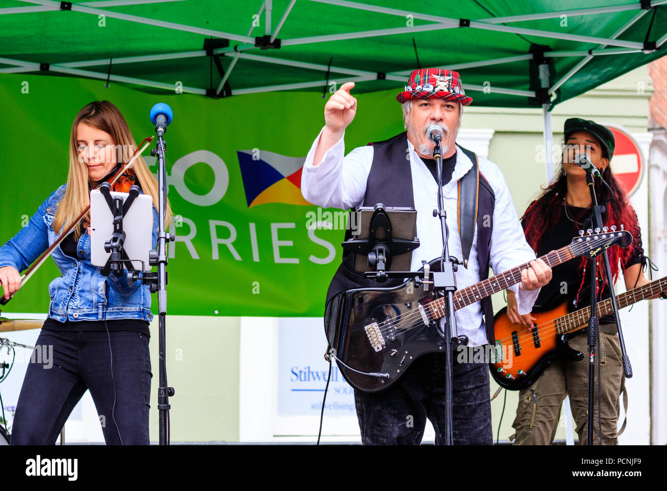 Close-up, waist up, Caucasian man, 40s, playing electric guitar at open ...