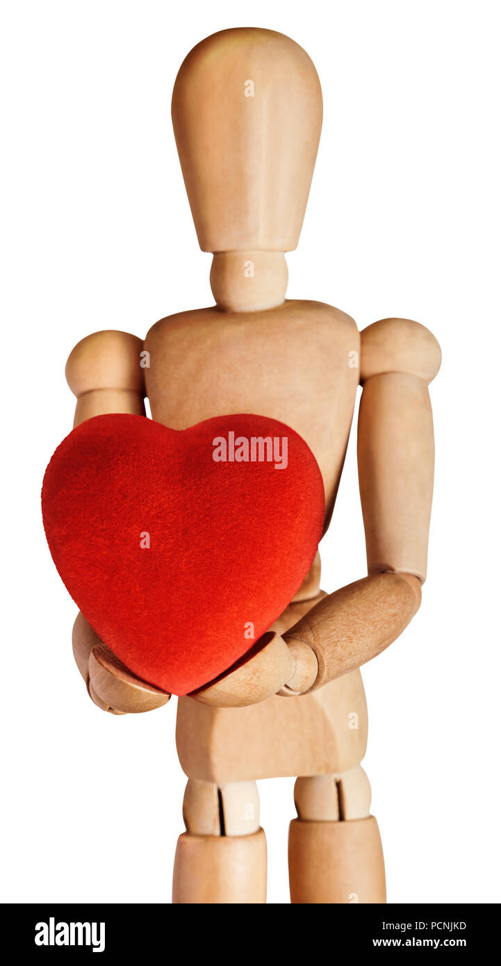 Wooden artist's mannequin, facing front and holding out a large, soft red heart in both hands. Isolated on white background. Stock Photo