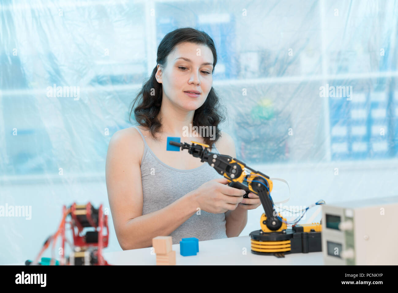 girl in a University laboratory is experimenting with a robot Stock Photo