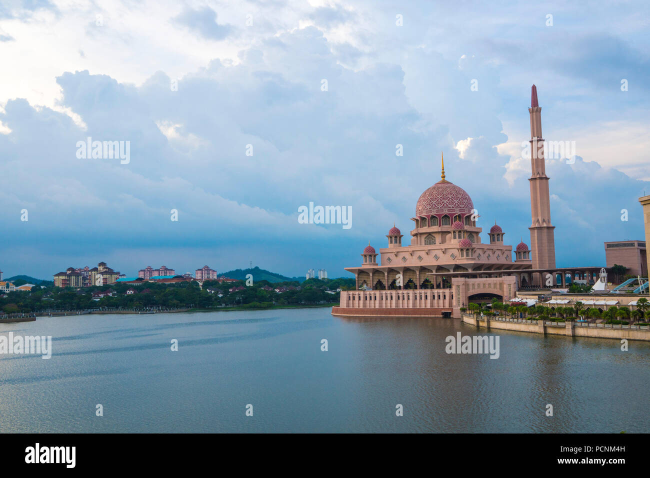 The Putra Mosque located in the Putrajaya, Malaysia which is made from rose-colored granite with a pink dome overlooking the Putrajaya Lake Stock Photo