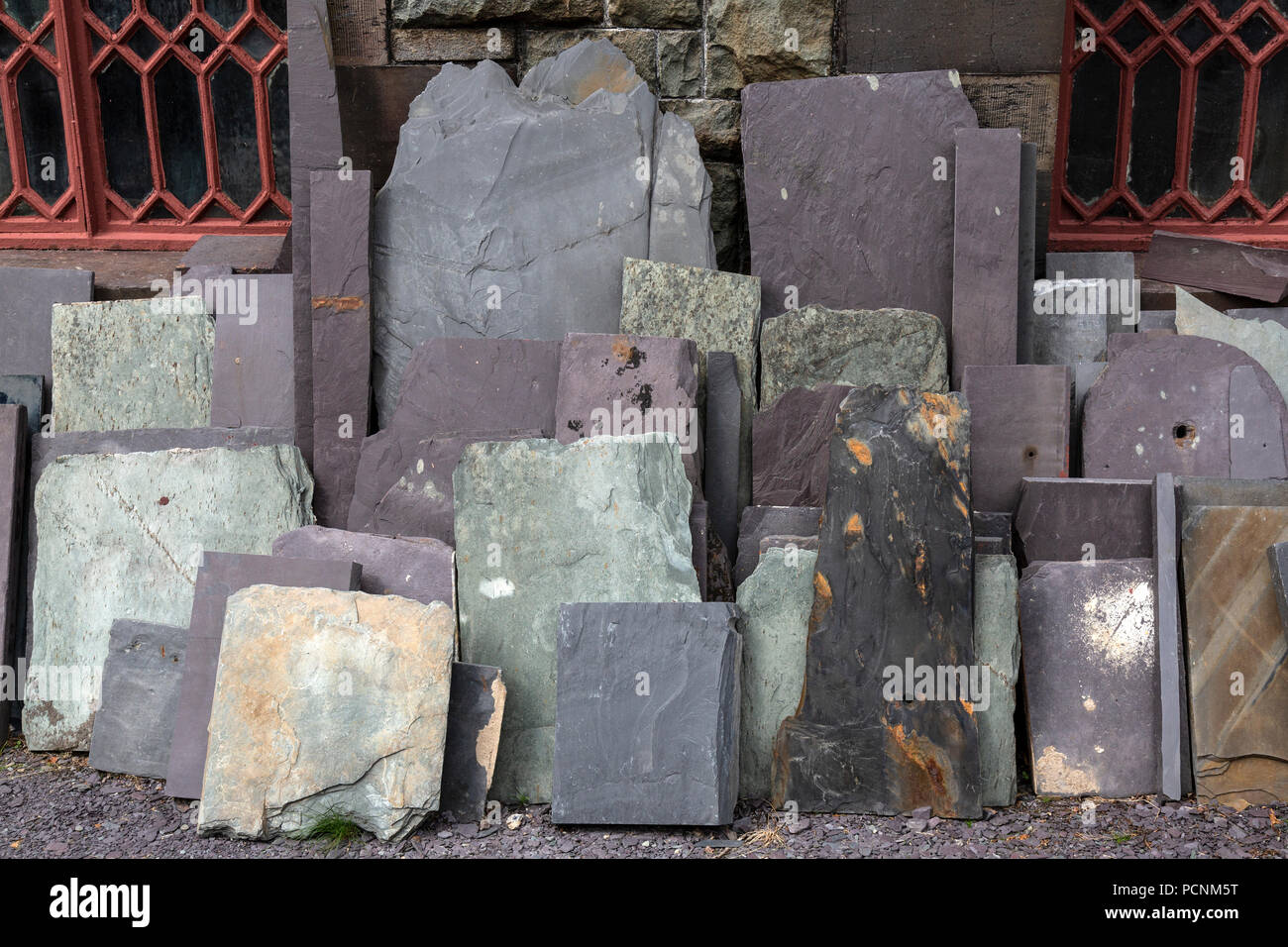 Pieces of slate of various colours and sizes, stacked against a wall at the National Slate Museum in Dinorwic, near Llanberis in Wales. Stock Photo