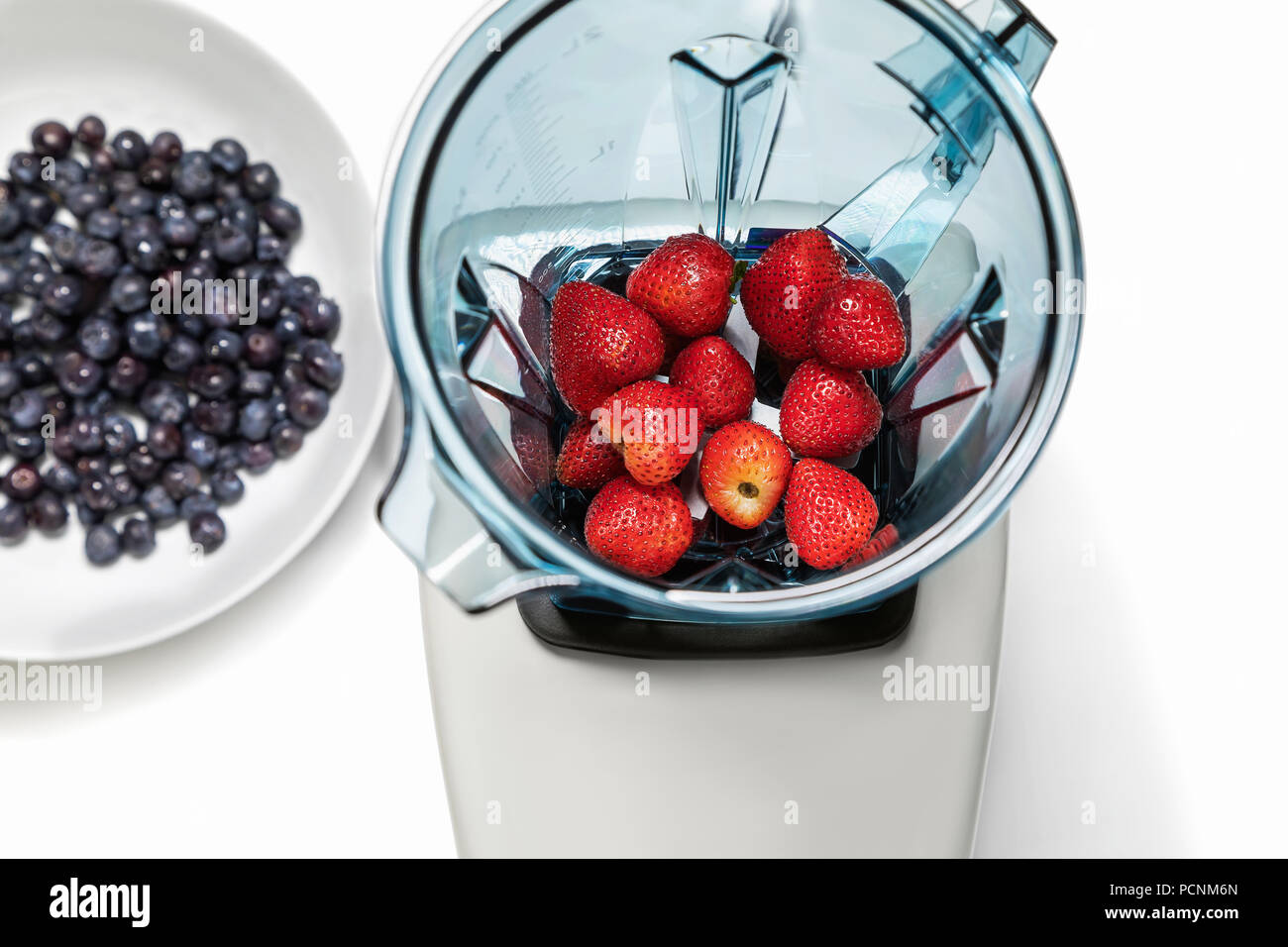 Series of shots. Photo 3. Strawberry in a blender, top view. Stock Photo