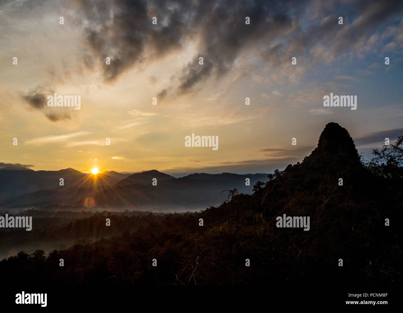 Silhouette of one of the quatz mountain peak located in the Klang Gates Quatz Ridge in Kuala Lumpur, Malaysia against beautiful morning sunrise. Stock Photo