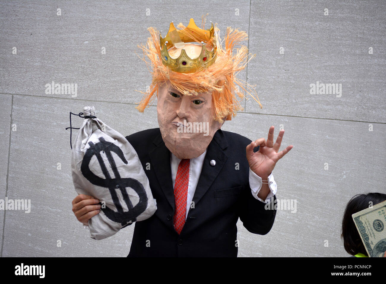 Man dressed as Donald Trump at protest against ICE on Wall Street in Lower Manhattan. Stock Photo