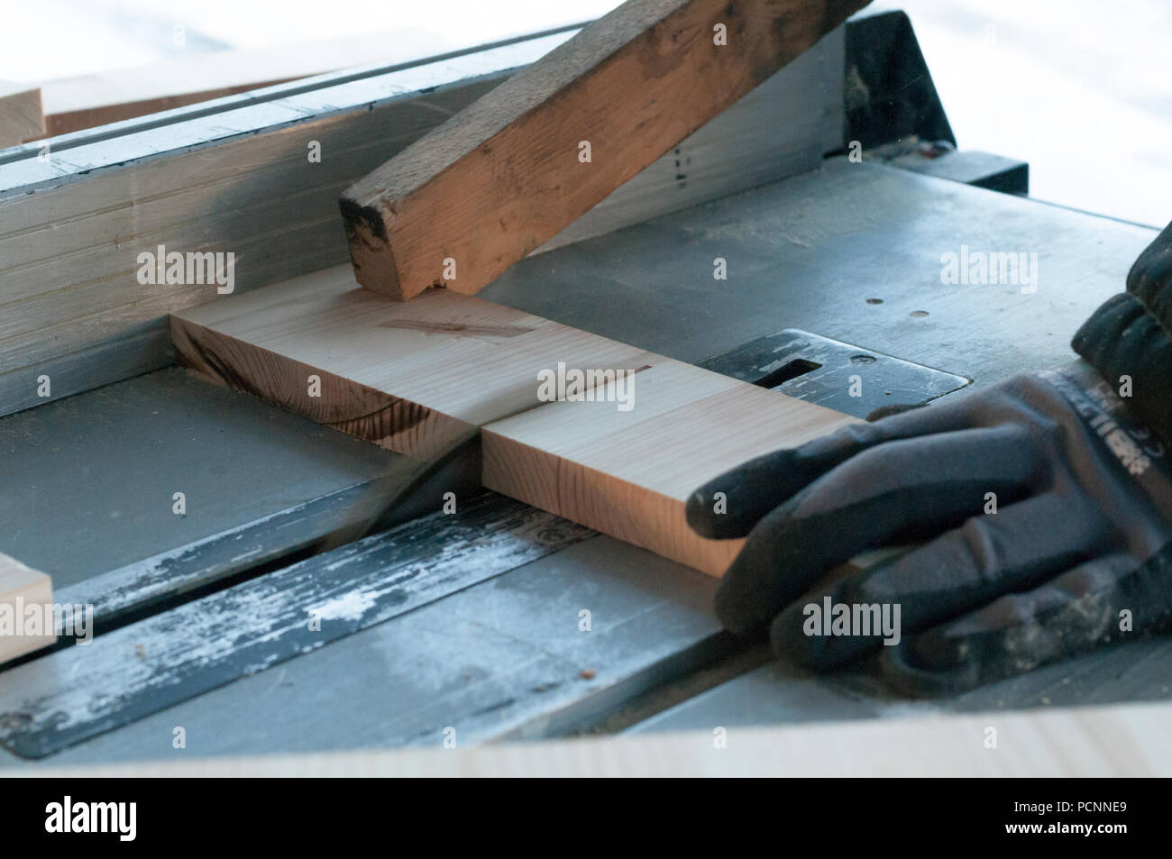 An action shot of a carpenter cutting wood using a wood cutting blade Stock Photo