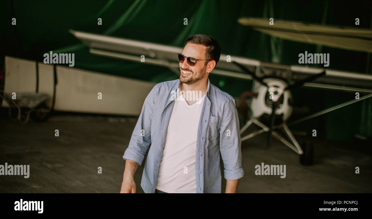 Handsome young pilot checking ultralight airplane before flight Stock Photo